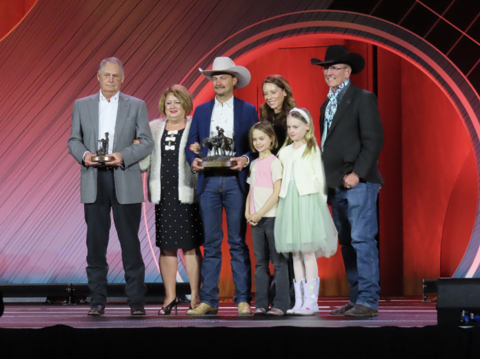 Wine Glass Ranch Cattle producers and family members on stage receiving the Environmental Stewardship Award during CattleCon 2026